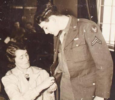 Mrs Baldry repairs a GI's uniform for the American Red Cross. (Digital archive reference MC 371/410)